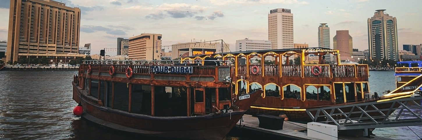 Traditional boats on Dubai Creek at sunset