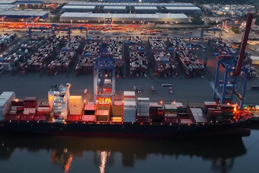 Container terminal with ships and cranes at dusk